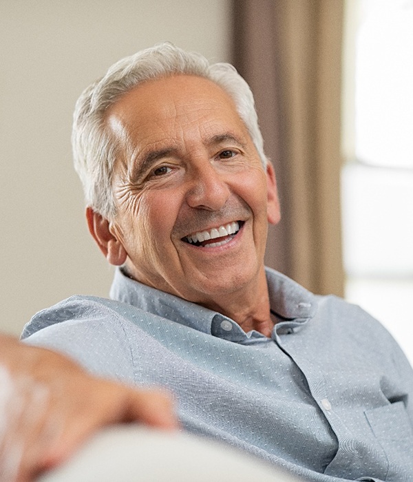 Smiling older man with dental implants in Colorado Springs