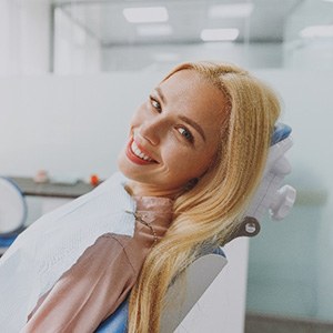 Young woman smiling while relaxing in treatment chair
