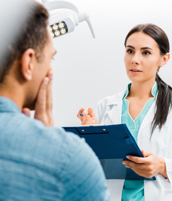 a patient discussing with dentist about wisdom tooth extractions
