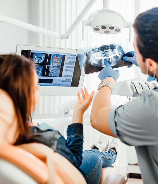 A periodontist showing a patient their X-rays
