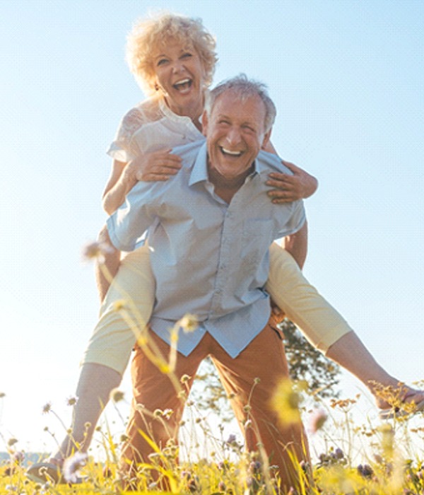 happy couple who have had bone grafting and now have dental implants in Colorado Springs