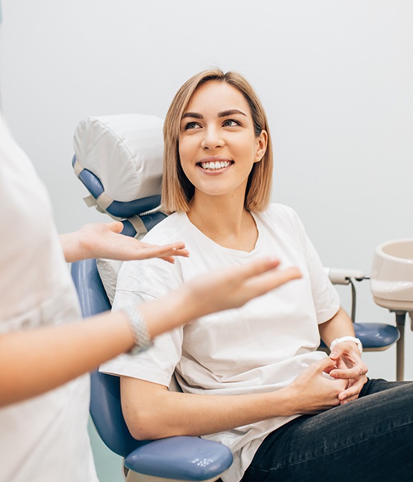 Woman in dental chair smiling at periodontist