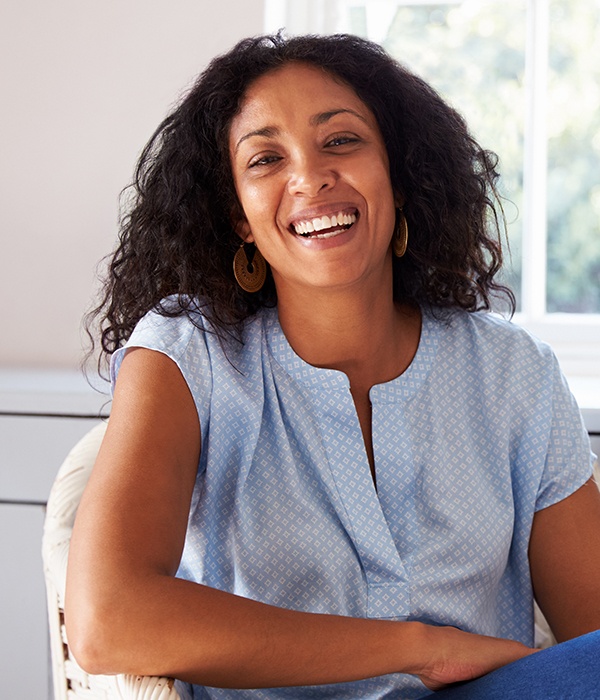 Woman with healthy smile laughing after gum disease treatment