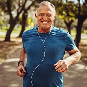 Healthy man with dental implants in Colorado Springs jogging