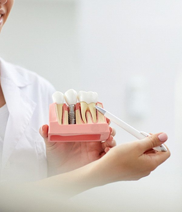 Periodontist in Colorado Springs explaining dental implants to patient