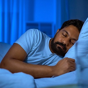 Sleeping man following dental implant post-op instructions in Colorado Springs