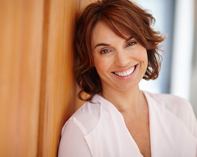 Woman sharing a dental implant retained denture