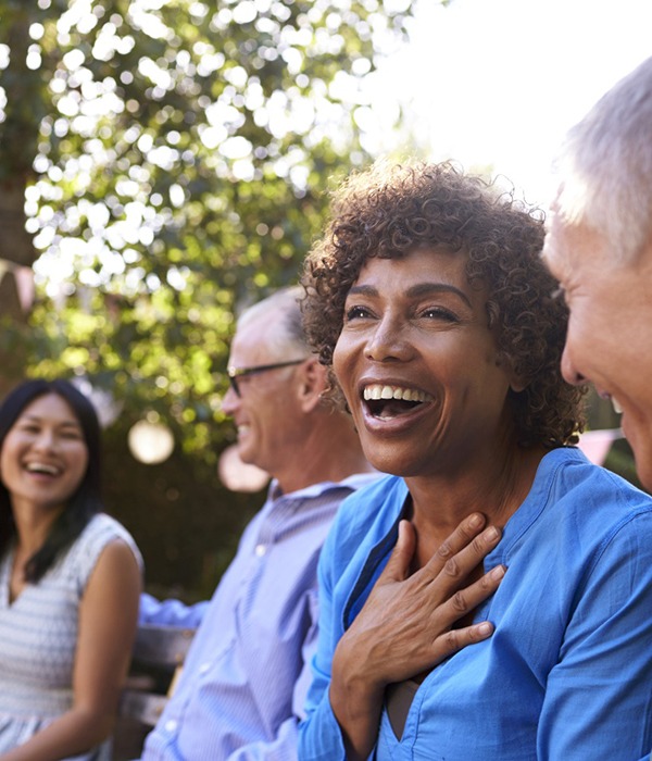 Diverse group of friends with dental implants in Colorado Springs laughing