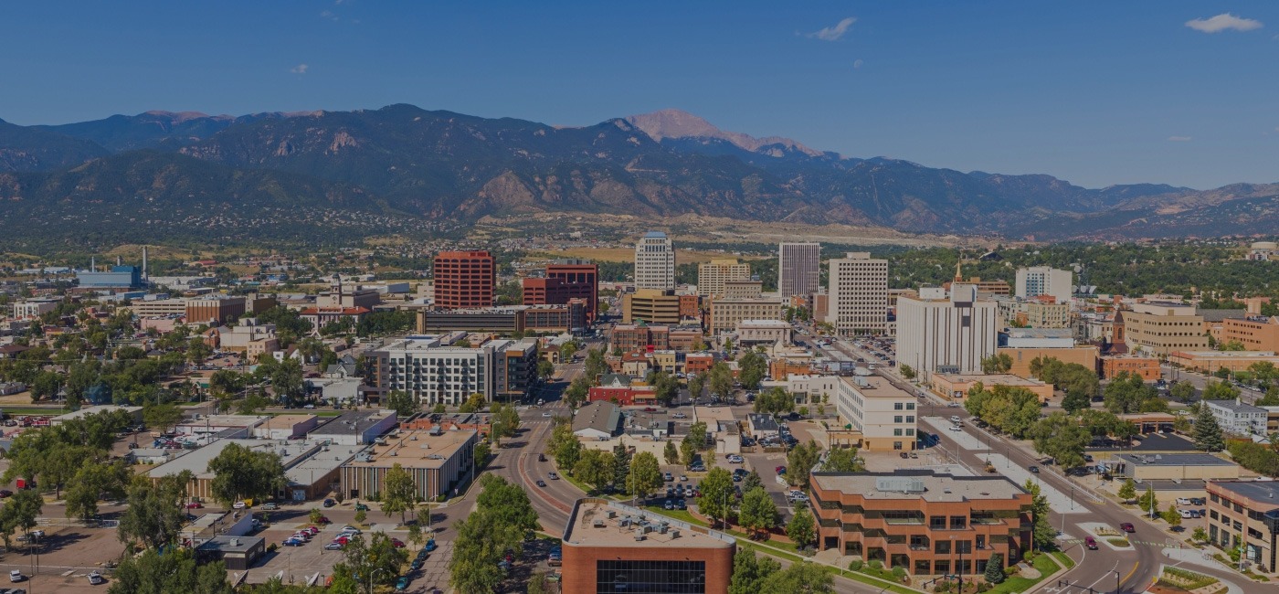 Aerial view of Colorado Springs with mountains in background