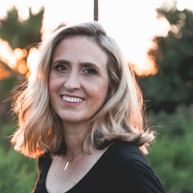 Woman in black blouse smiling outdoors