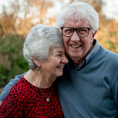 Senior man and woman smiling together outdoors