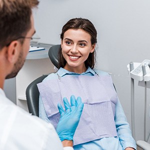 Female patient smiling at periodontist during consultation