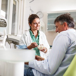 Dentist smiling at patient during consultation