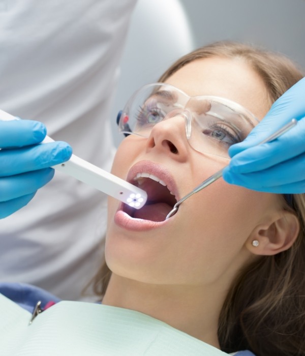 Dentist performing oral cancer screening