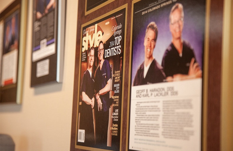 Images of periodontists from magazine articles framed on periodontal office wall