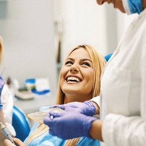 patient smiling while visiting dentist