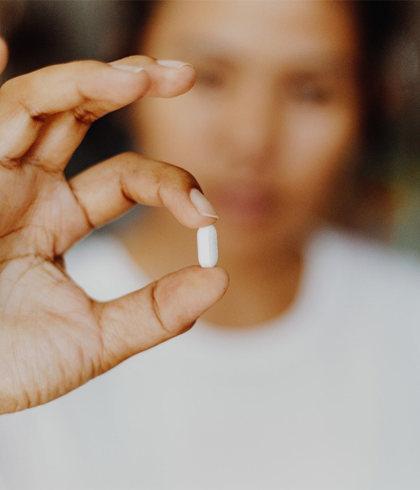 a closeup of a patient holding a pill in Colorado Springs