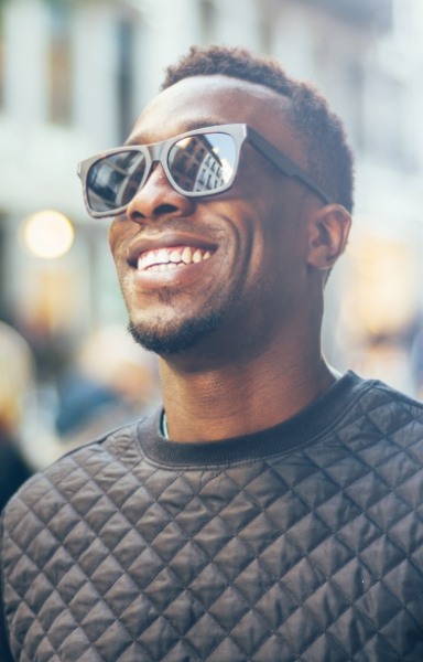 Man with flawless smile after dental implant tooth replacement