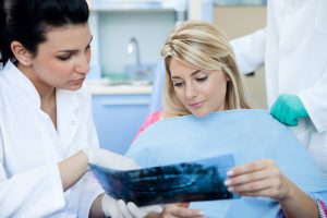 Woman  and dentist looking at x-rays