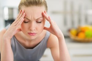 Woman under a lot of stress experiencing bleeding gums.