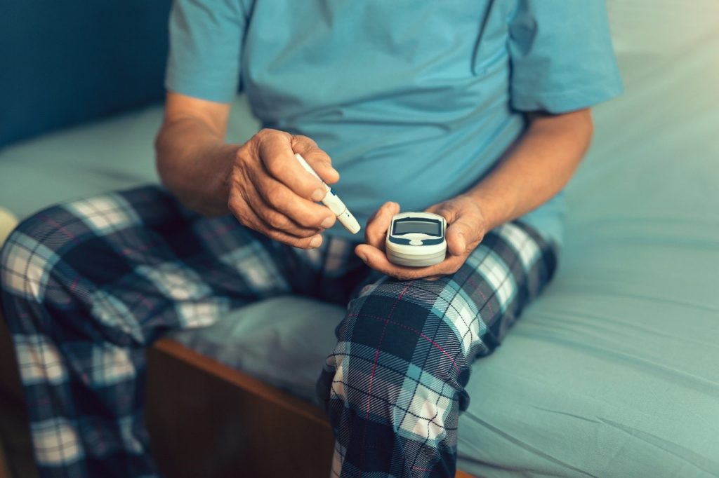 Patient with diabetes checking his blood sugar levels.