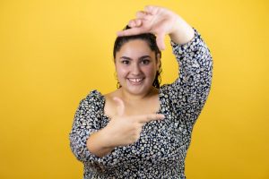 woman placing her hands around the shape of her face